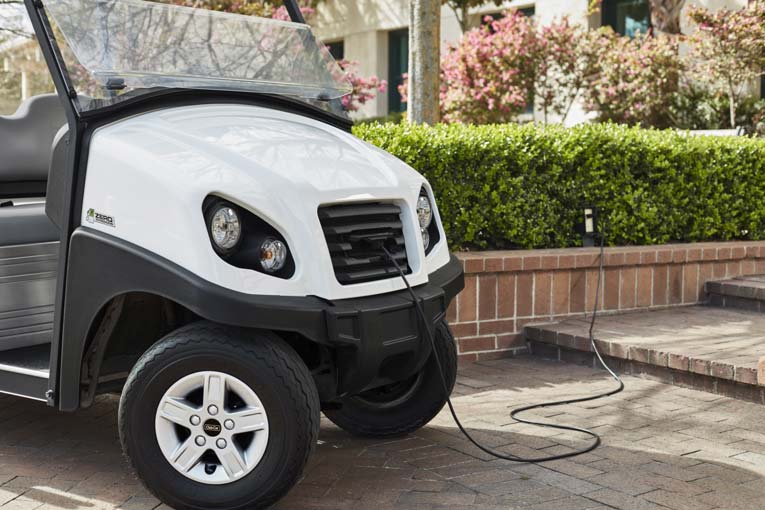 Electric campus utility vehicle with retractable charge cord