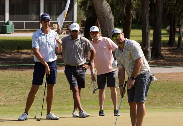 Golfers watching at hole