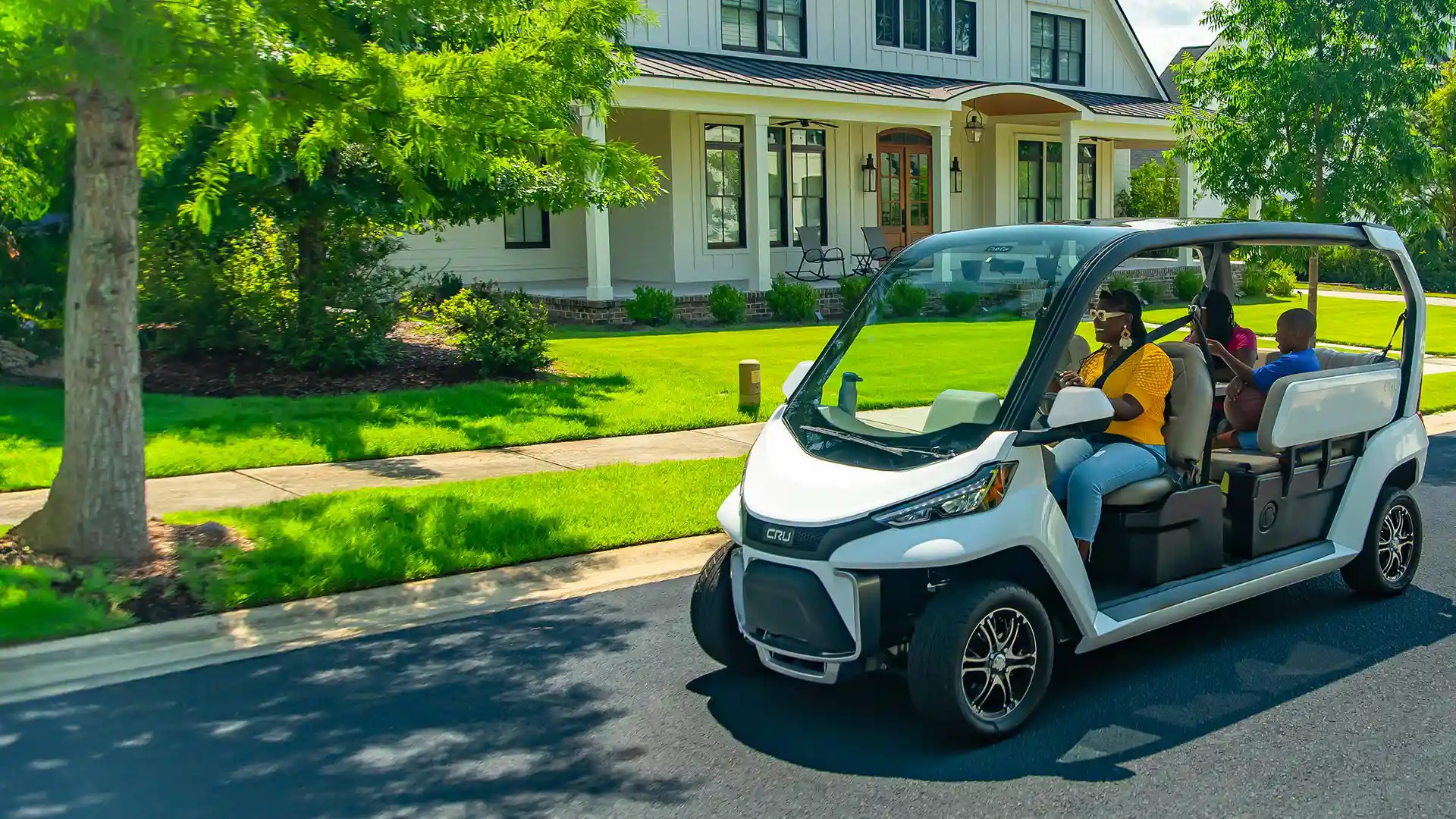 CRU neighborhood electric vehicle driving on residential street