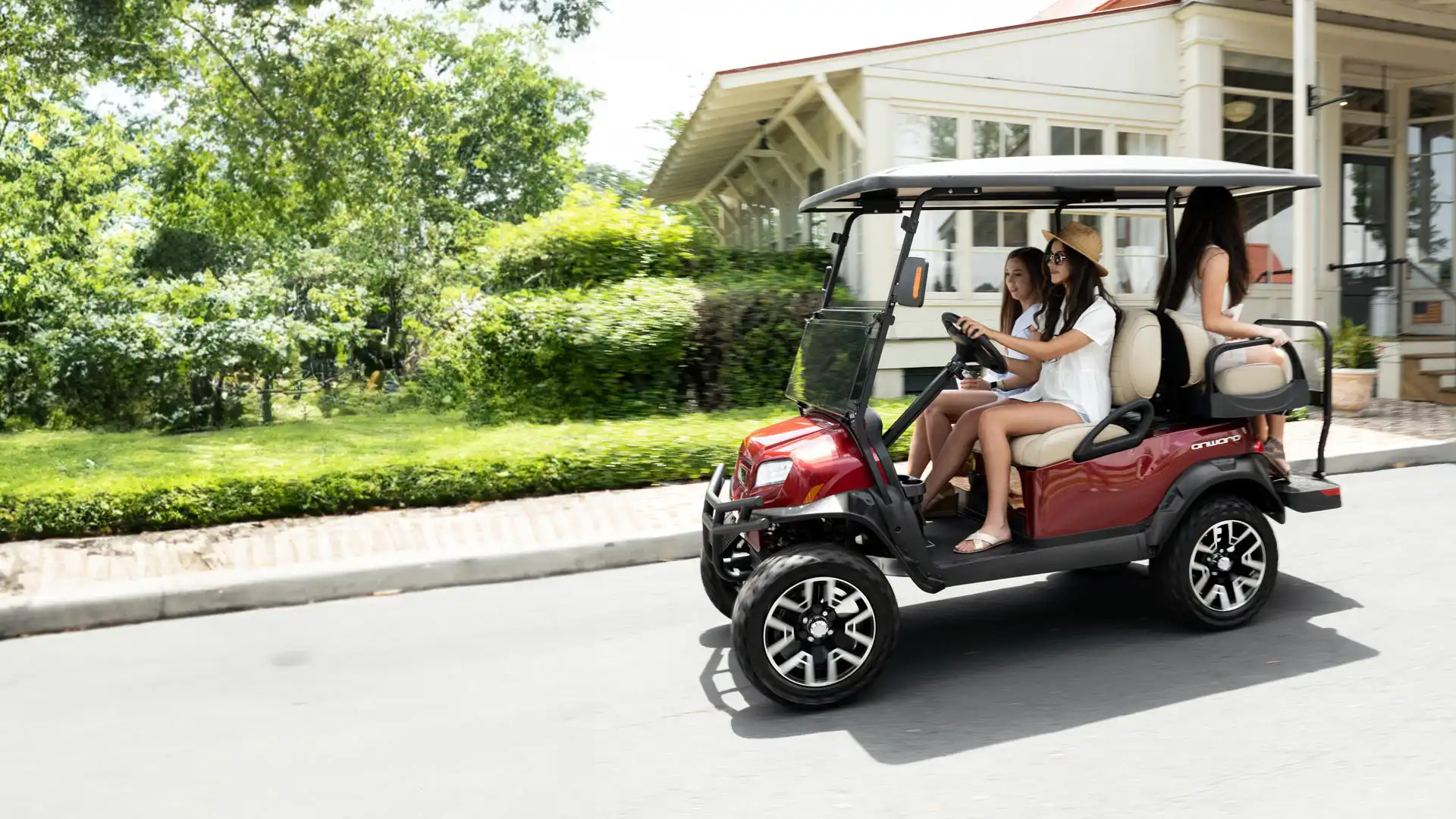 Onward red lifted 4 passenger golf cart in motion