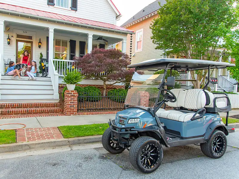 grey 4 passenger golf cart with custom wheels and seats