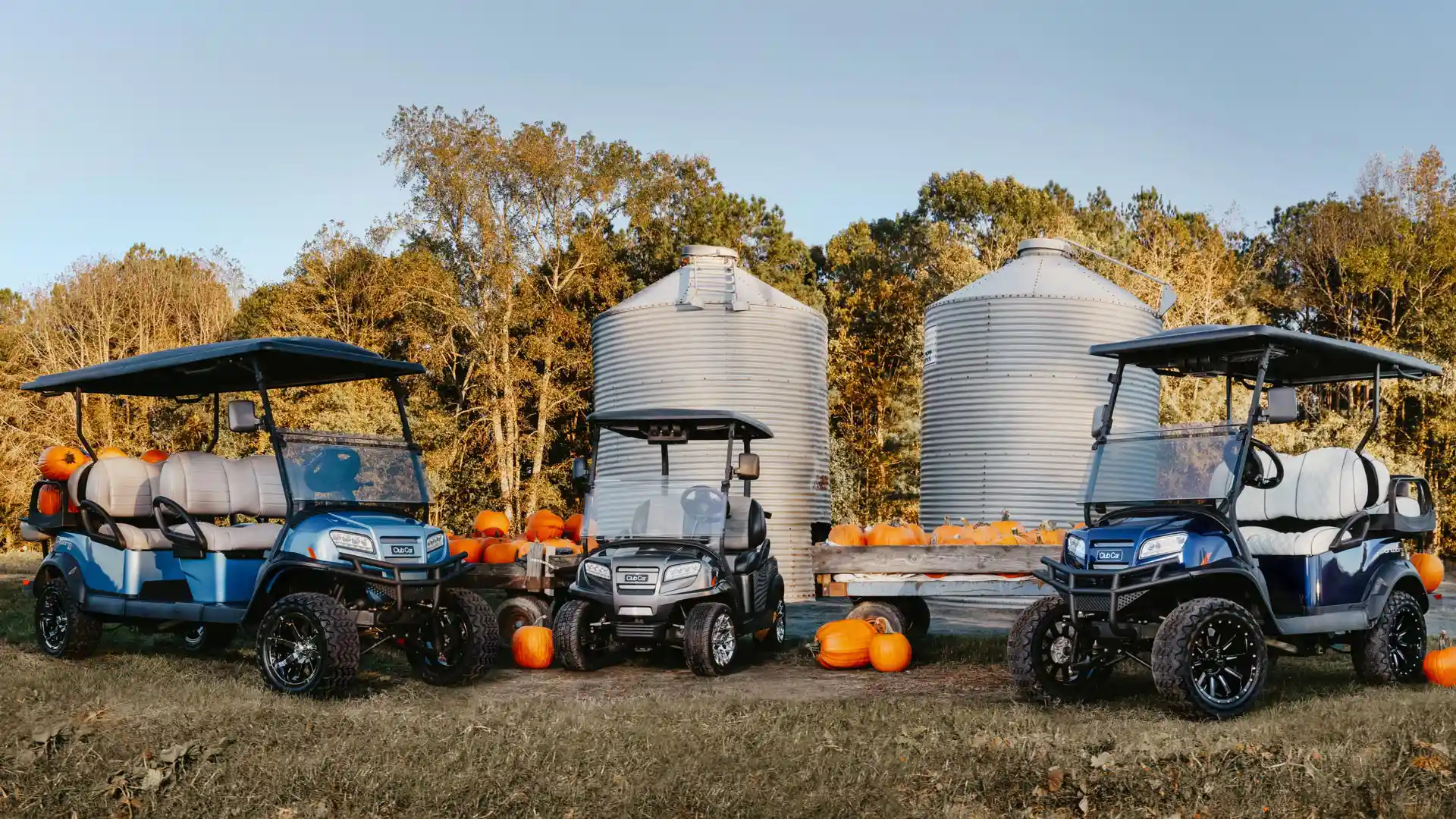Onward 6 passenger, 2 passenger, and lifted 4 passenger golf cart in autumn scene