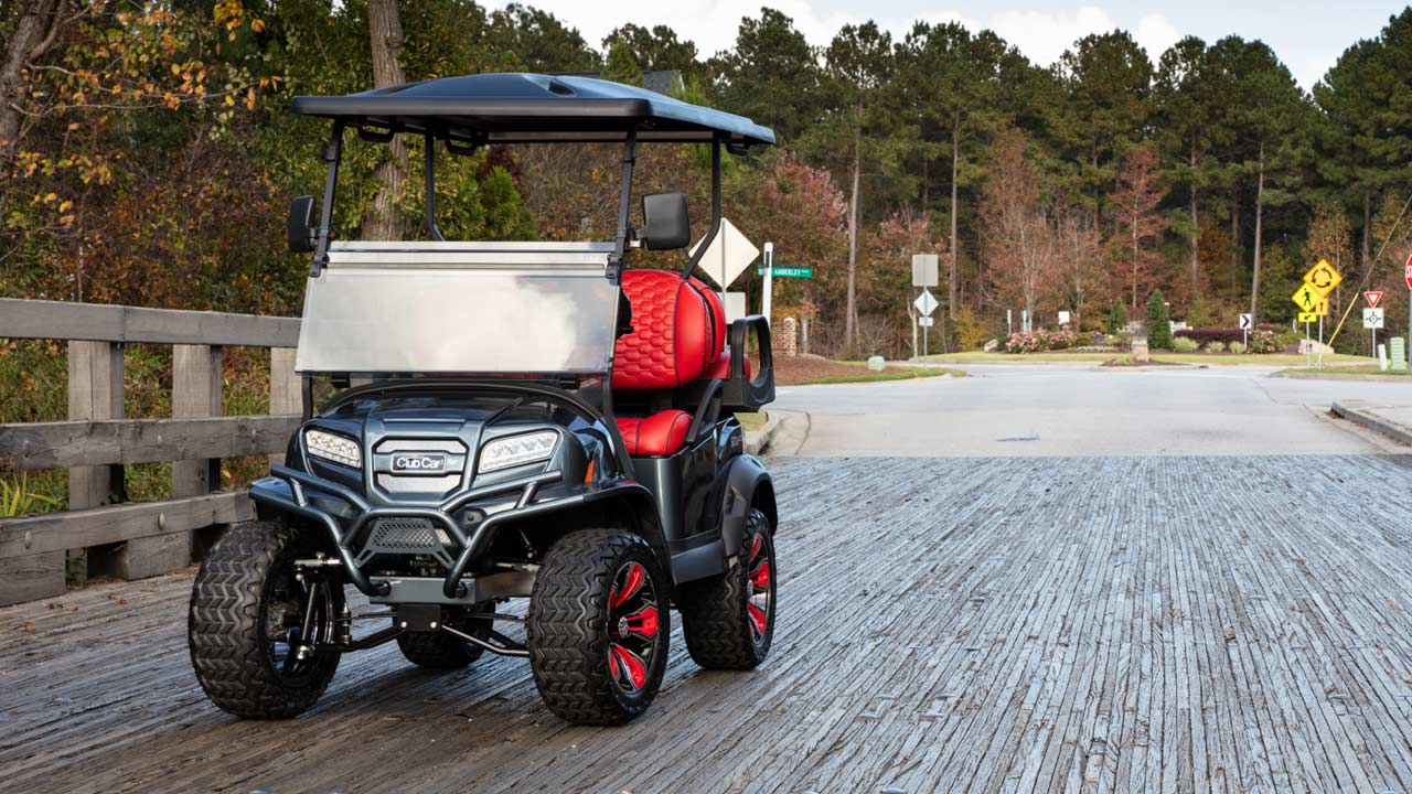 Lifted grey 4 passenger golf cart with custom seats