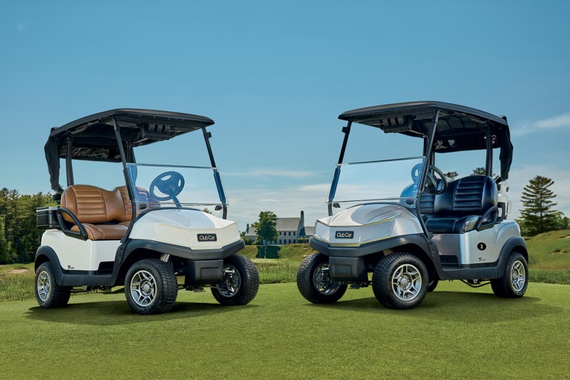 Two Tempo golf carts on golf course green
